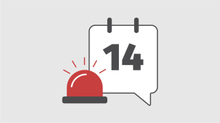 Ein Kalenderblatt vor dem Warnlicht steht